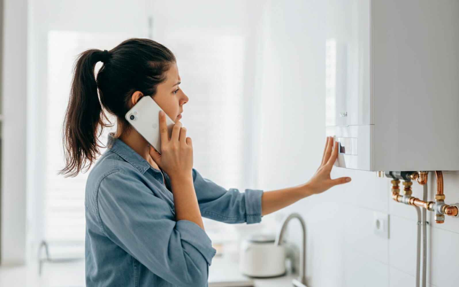 A woman inspecting a boiler