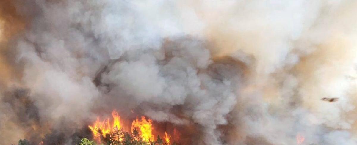 Exhausted crews battle Canadian wildfires as experts issue climate warning