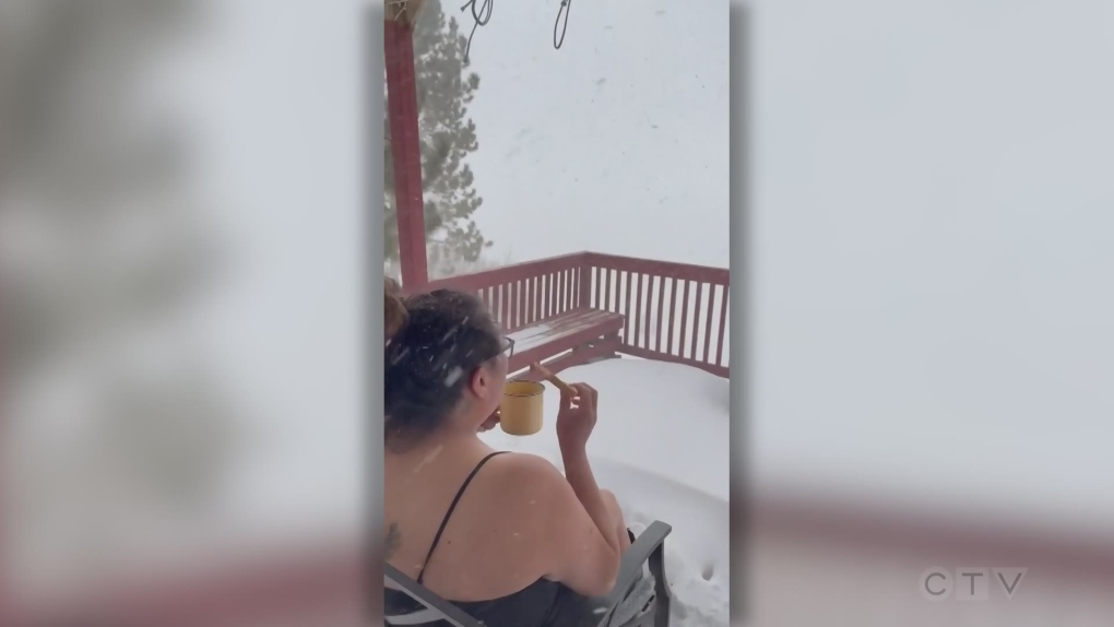 Woman having breakfast outside during snow storm