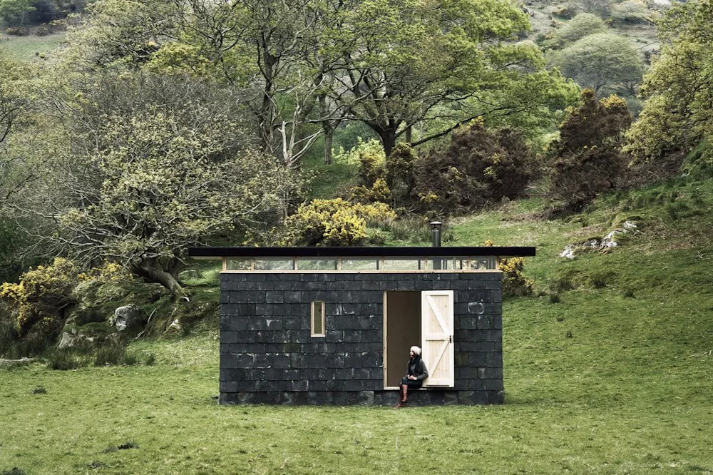 An Austere Off-Grid Cabin in Wales Relies on Reclaimed Slate