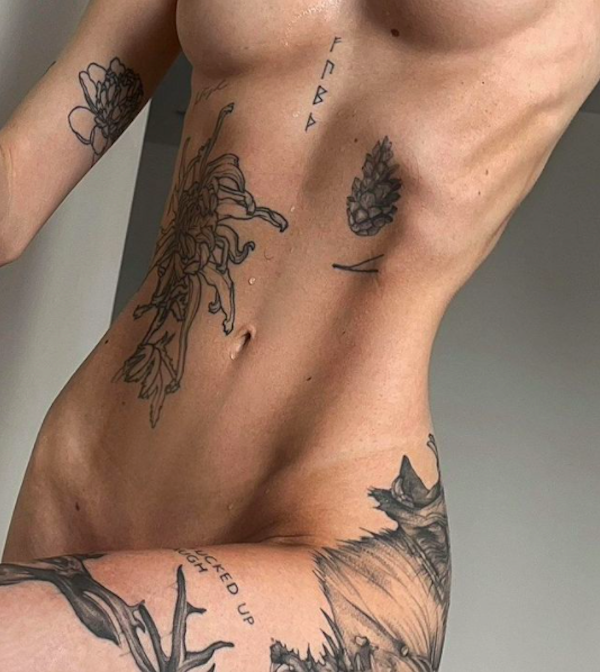 partial view of young and sensual woman with sexy tattooed body