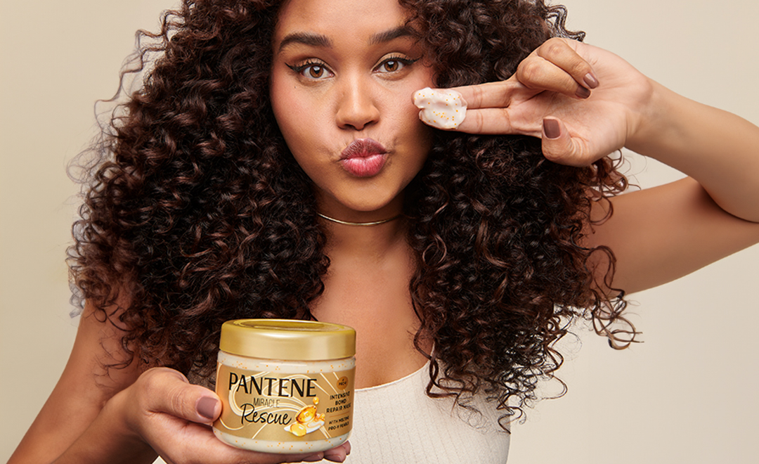 Brunette woman holding pantene miracle repair mask