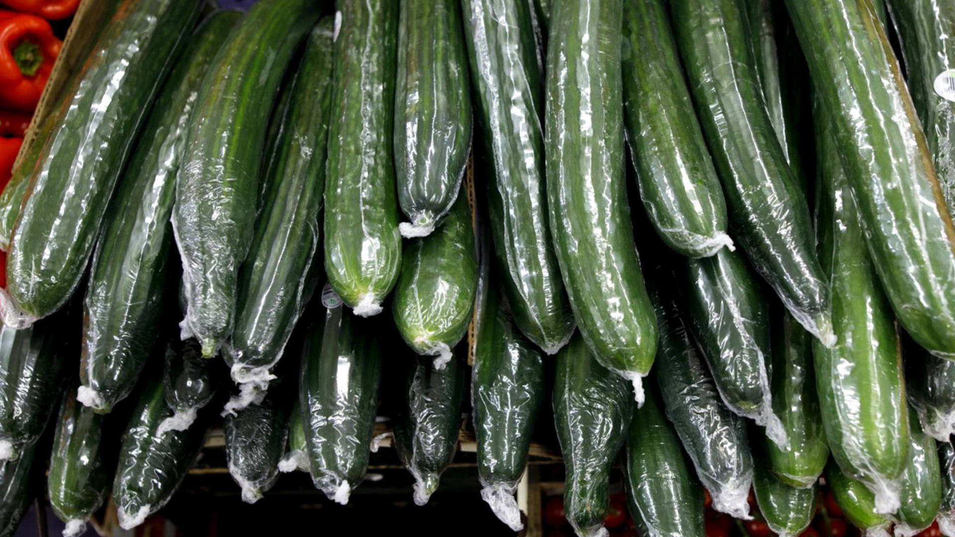 Stacked cucumbers wrapped in plastic