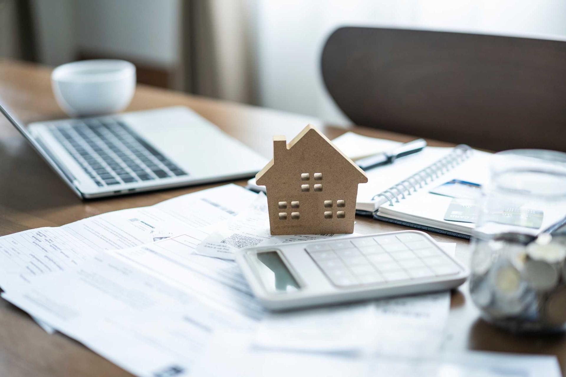 Calculator and paper documents lie on a kitchen table