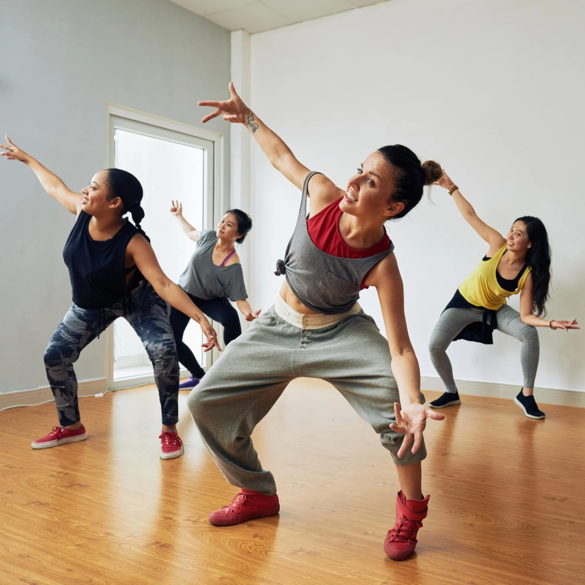 Various female-presenting people in a dance class