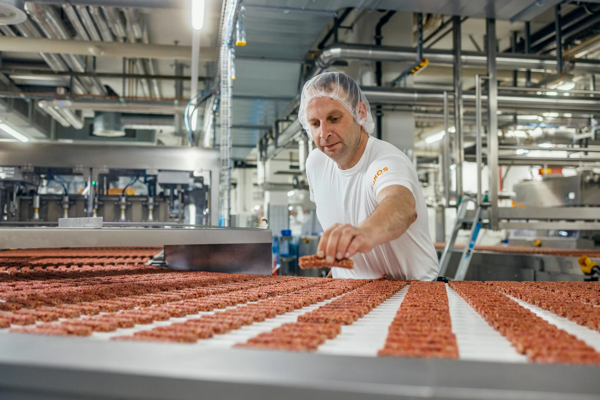 An employee checks Farmer bars on the assembly line