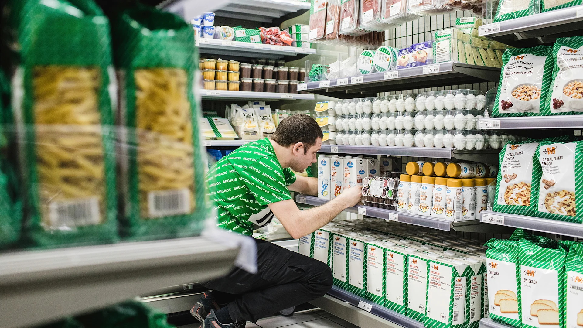 An employee restocks shelves in an M-Budget pop-up store.