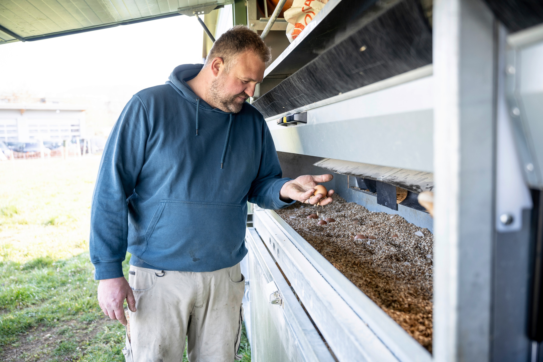 A farmer gathers eggs