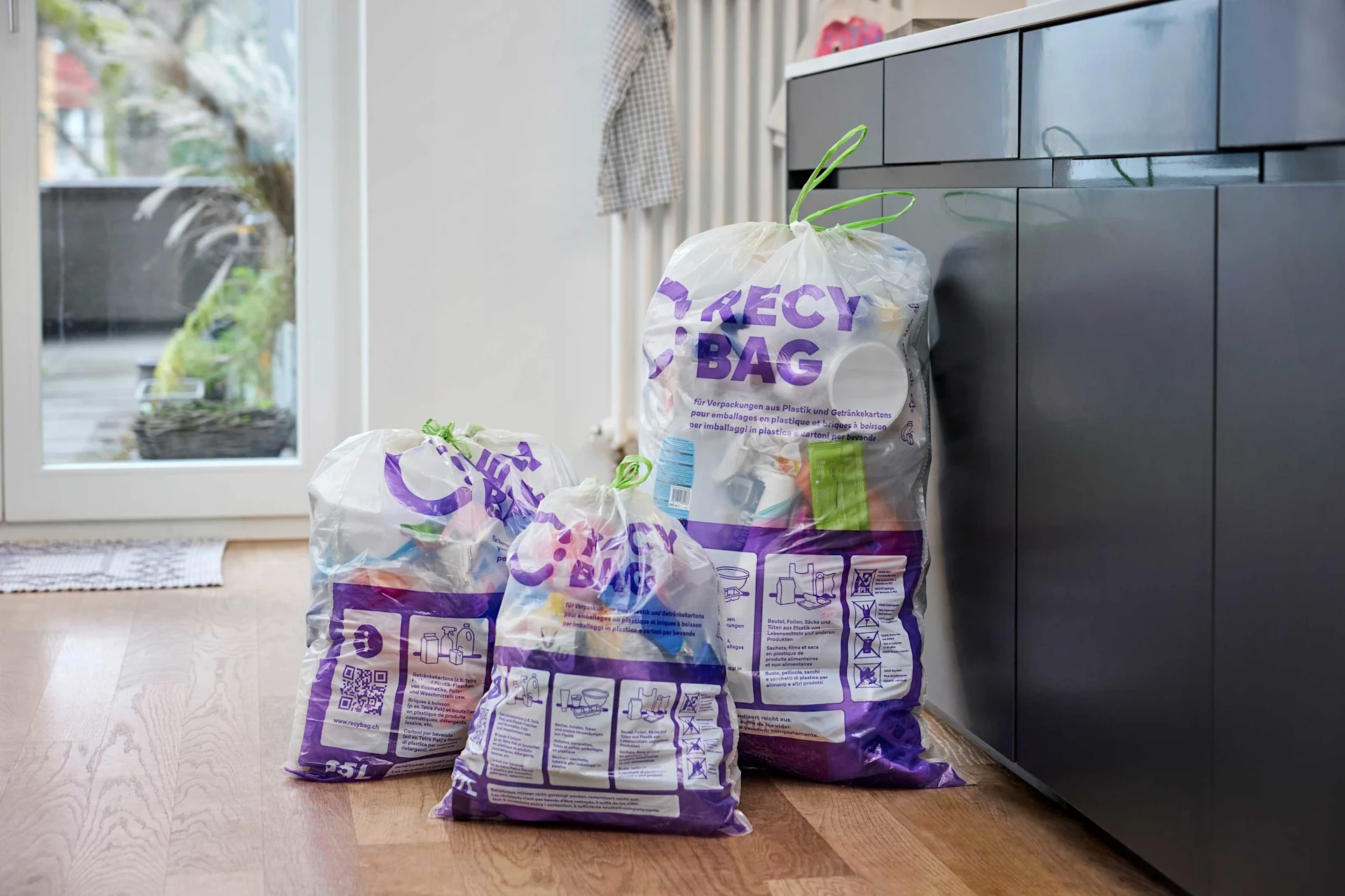 Three Recbags in different sizes are in a kitchen.