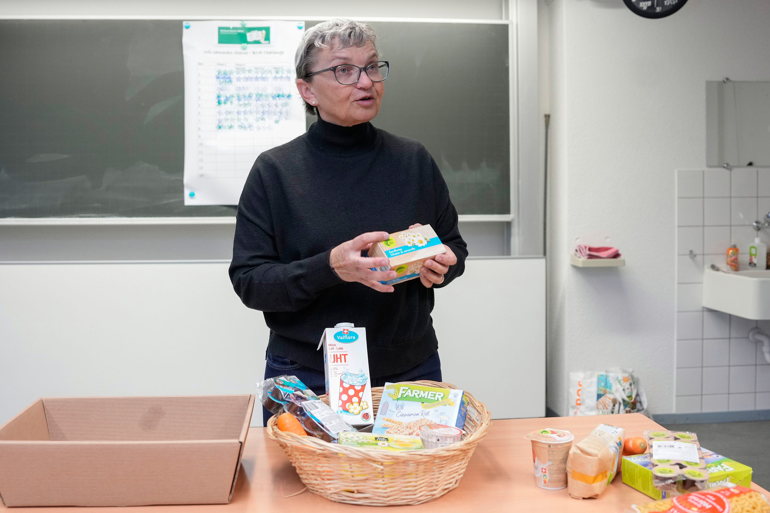 Teacher Elvira Schoch holding Migros products