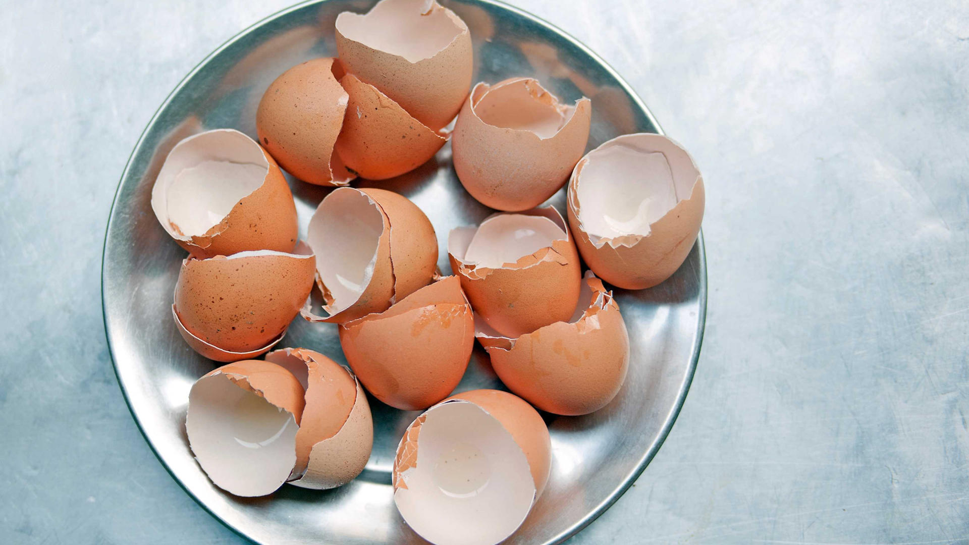 Zerschlagene Eierschalen auf einem silbernen Teller