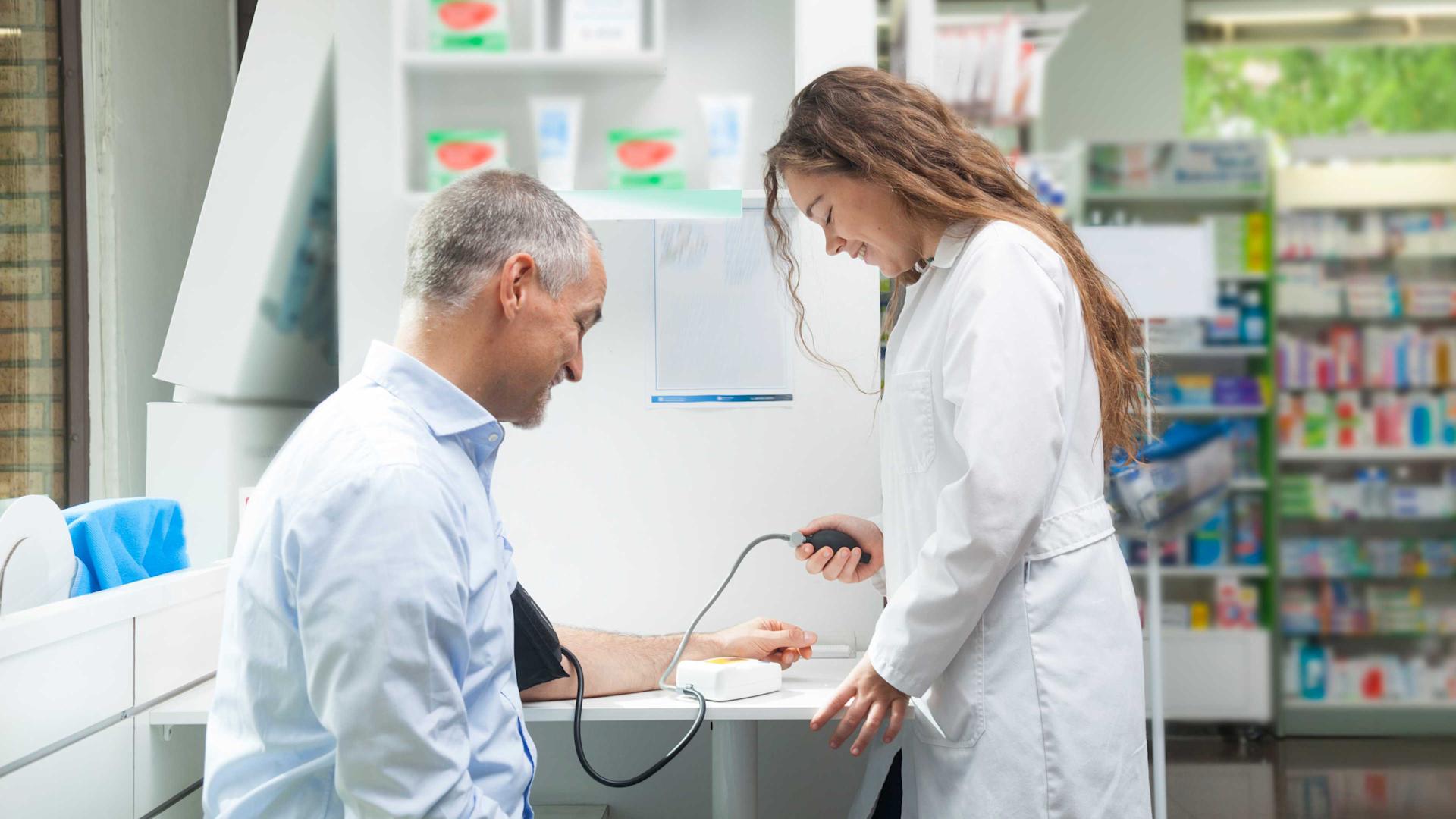 A man has his blood pressure measured at the pharmacy