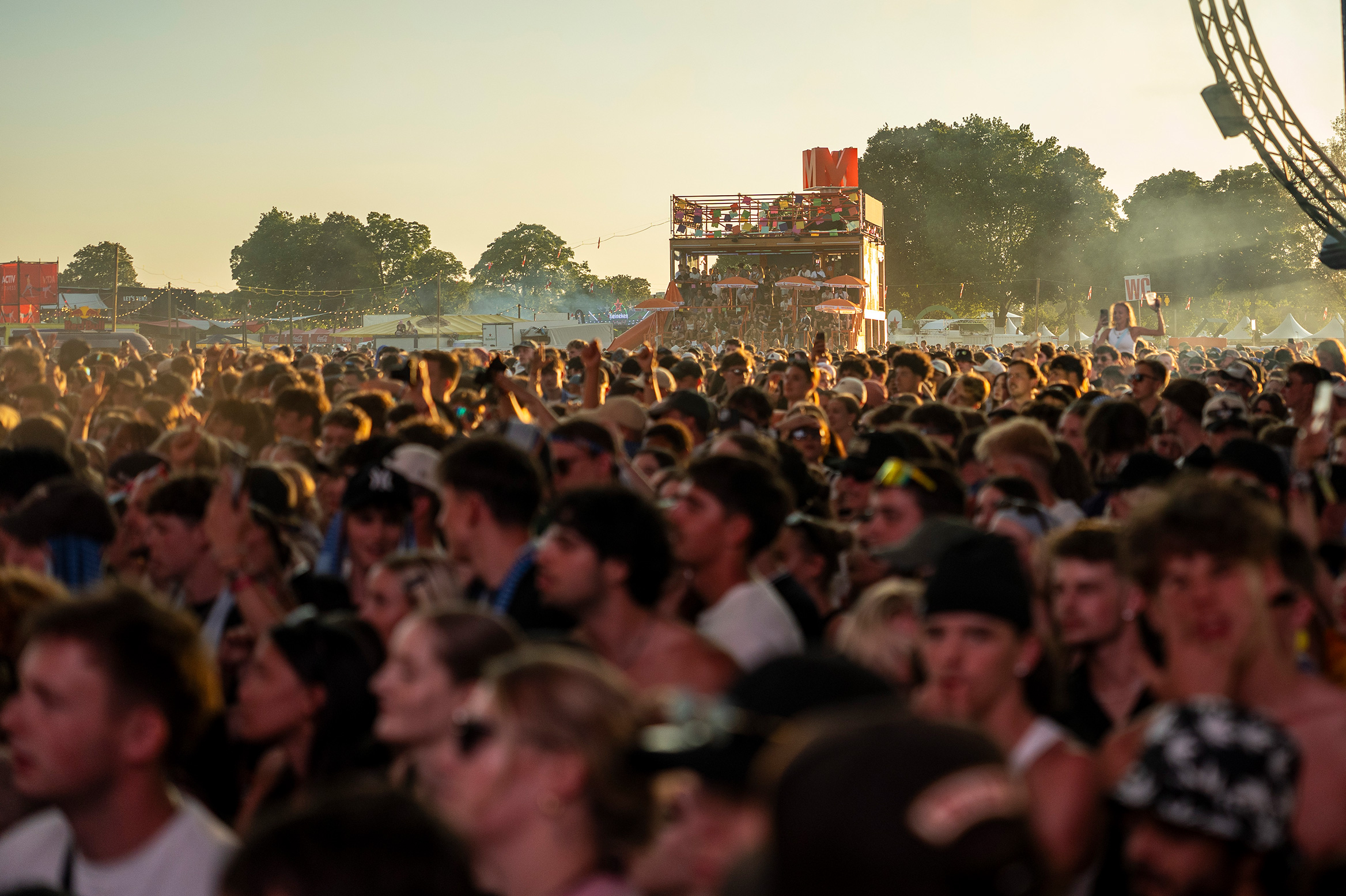 View over the dancing concert audience towards the Migros stand in the background.