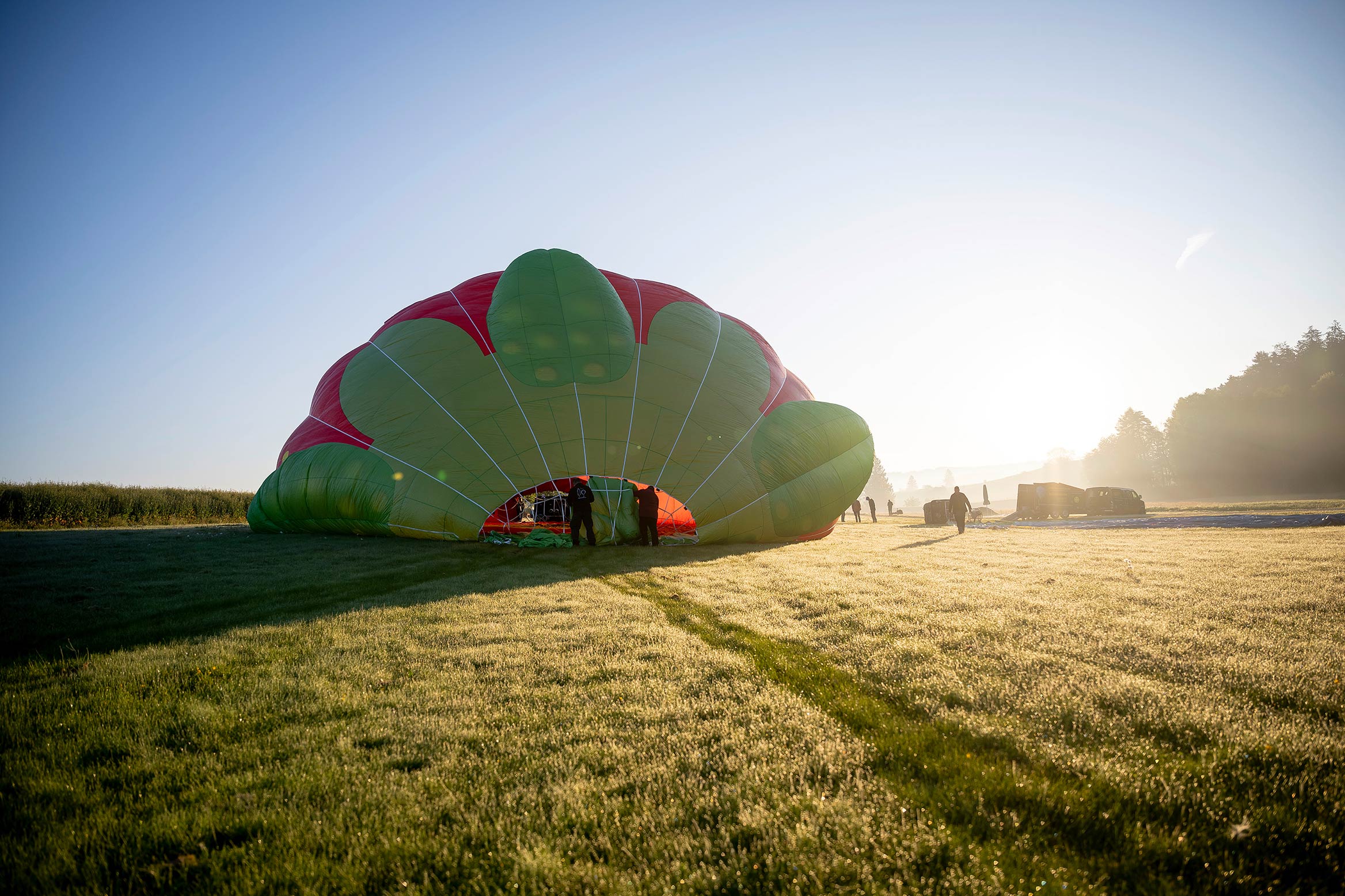 Hot air balloon taking off in a field