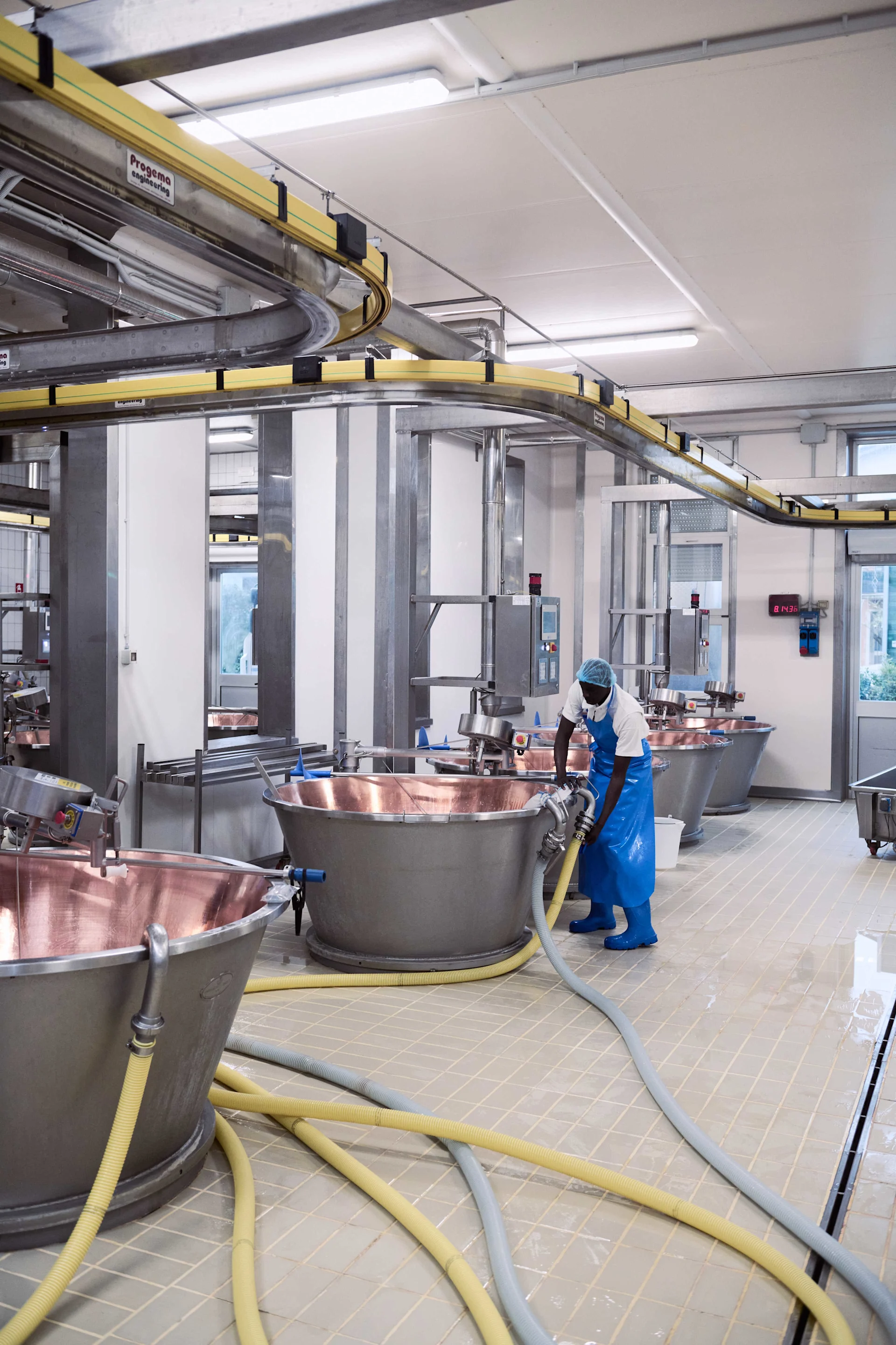 The cheesemaker adds whole milk first, then skimmed milk.