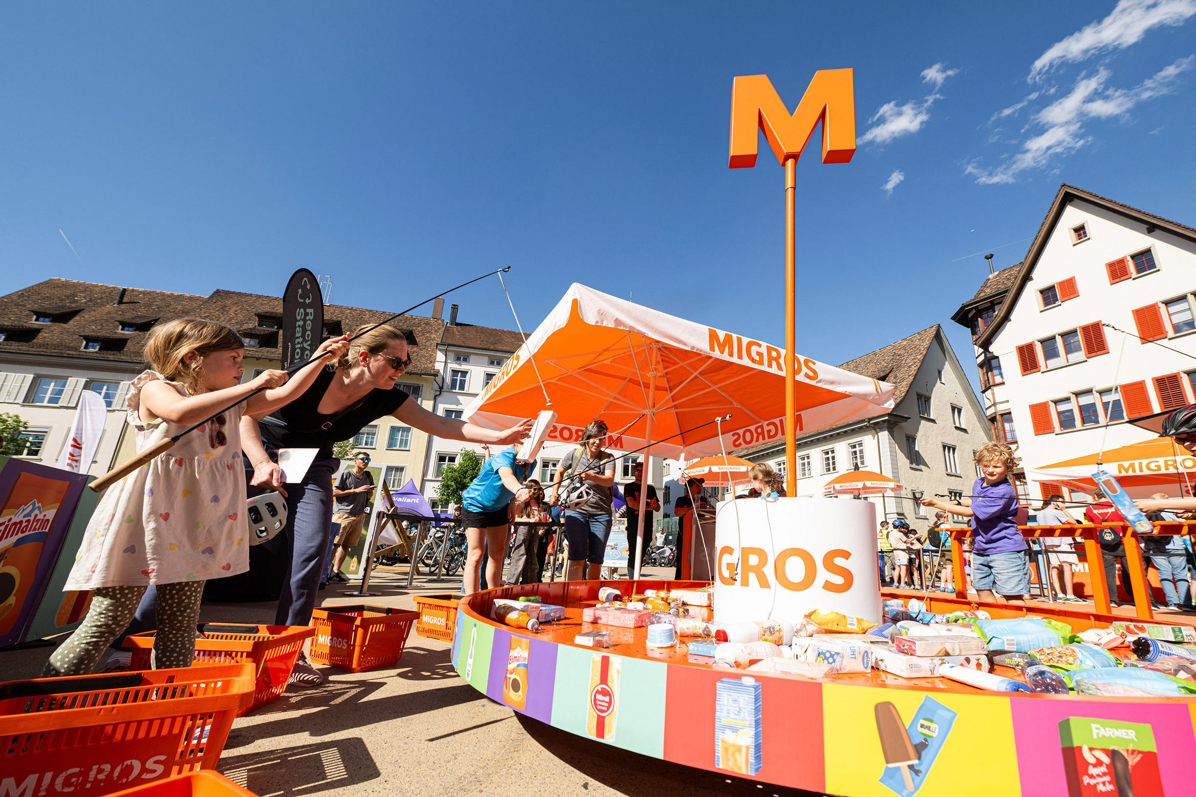 SlowUp participants fish for Migros products in a fun fishing game