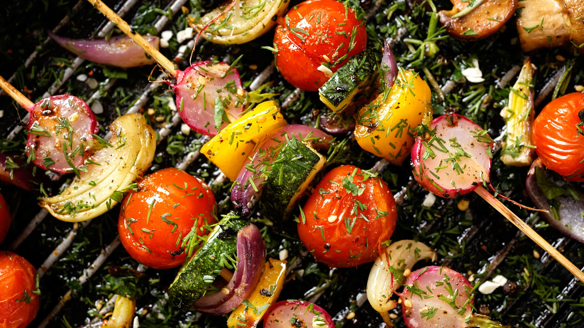 Vegetable skewers on a barbecue.