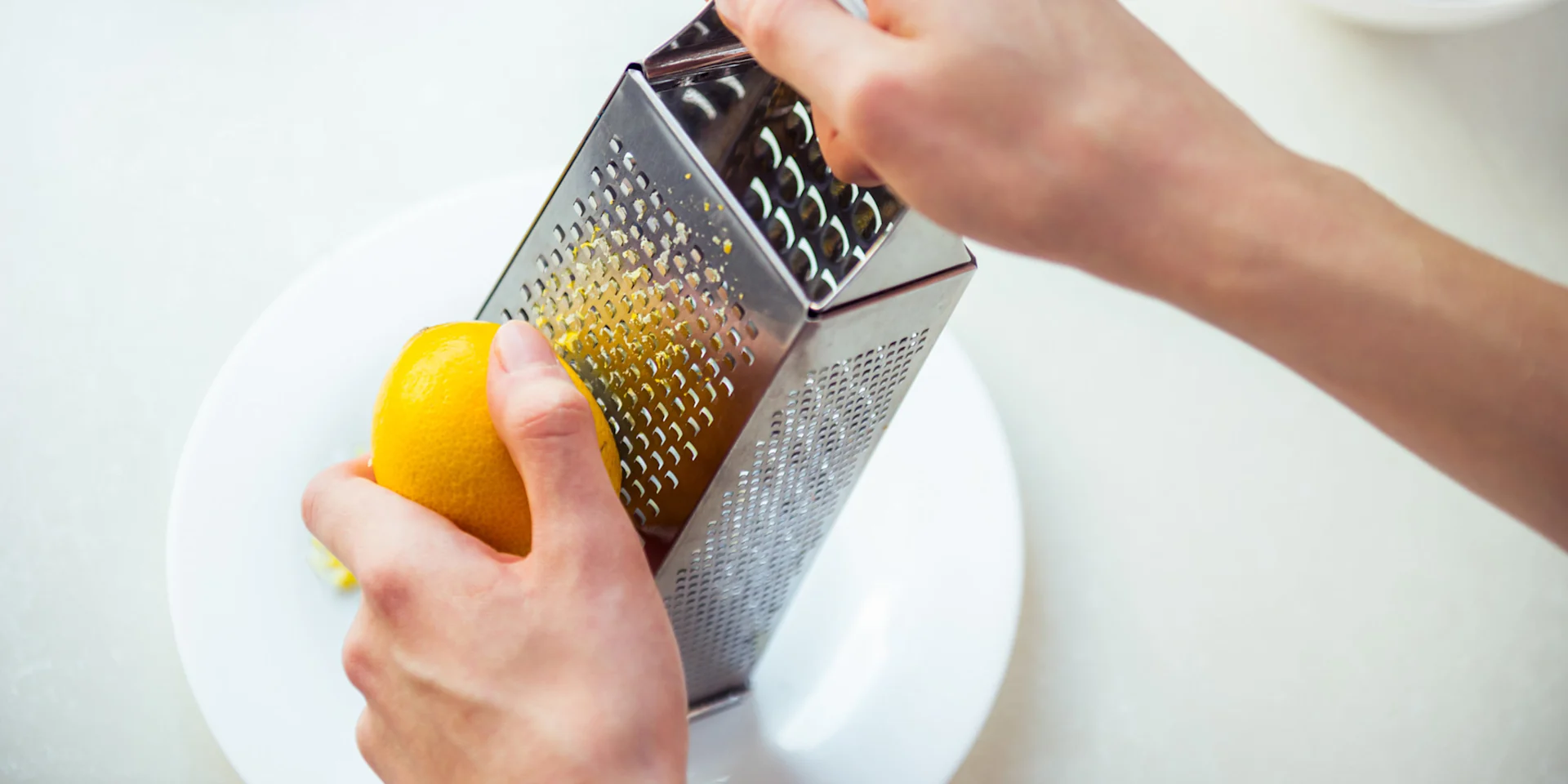 The zest of a lemon is being grated.