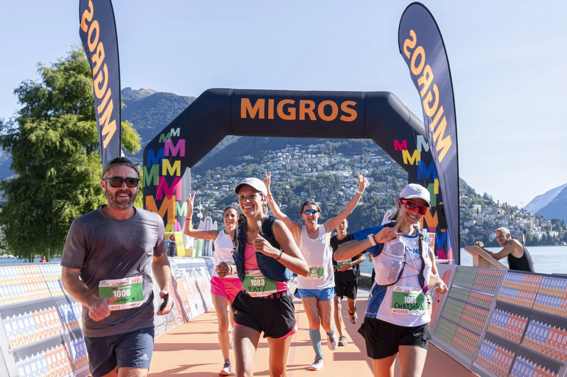 Runners cheer at the finish line of a Migros event.