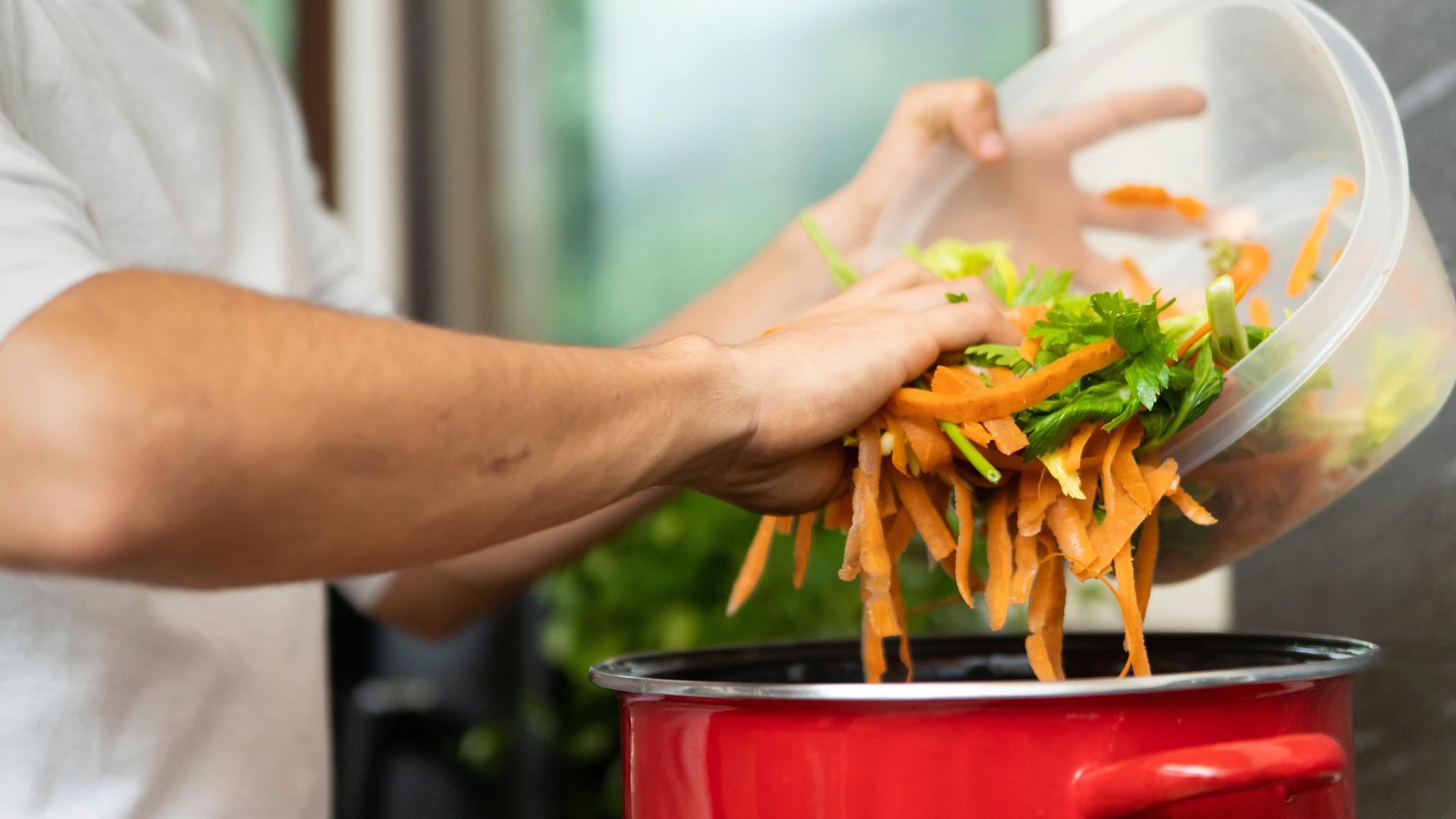 Catering waste is emptied into a pan