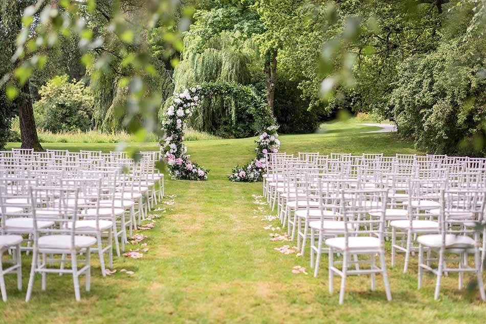Party seating and floral decorations for a wedding in the park