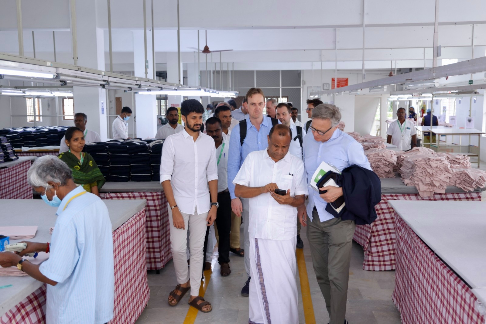 Sundar Murthy (front center) is guiding Mario Irminger through his textile factory.