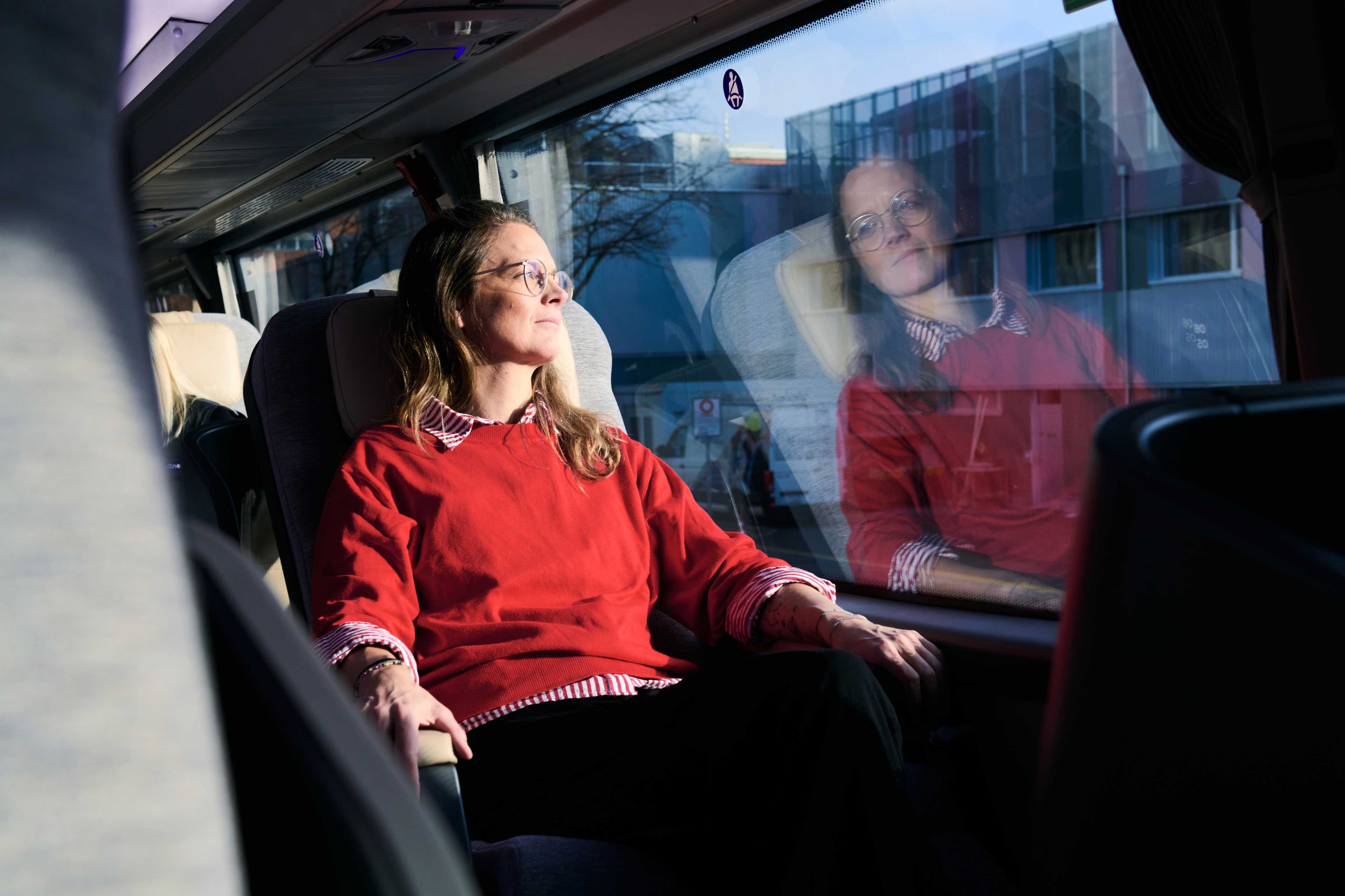 L'autore si siede comodamente nell'autobus e guarda fuori dal finestrino