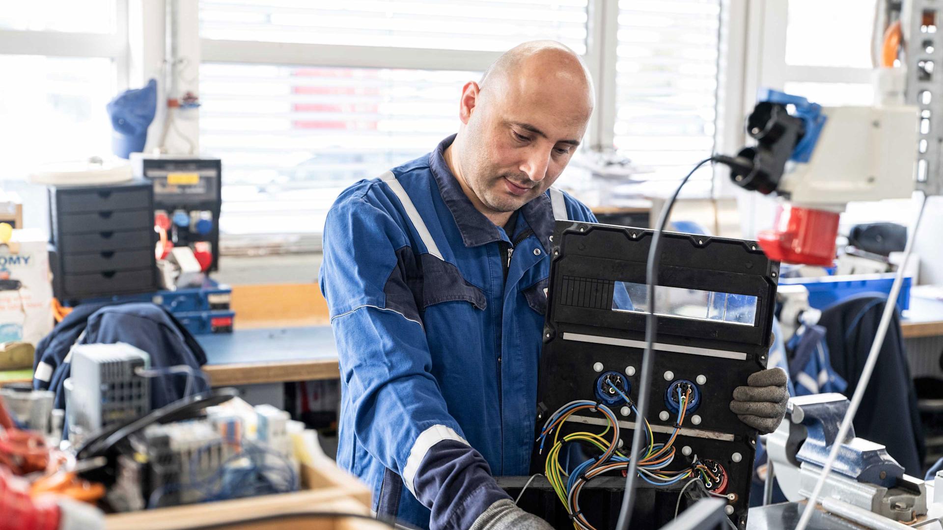 Kheradin Shati au travail en tant qu'apprenti installateur-électricien