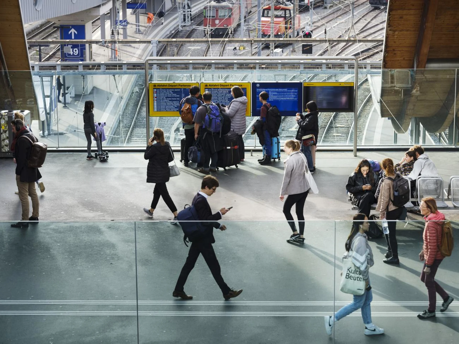 Travellers in a hall at a train station