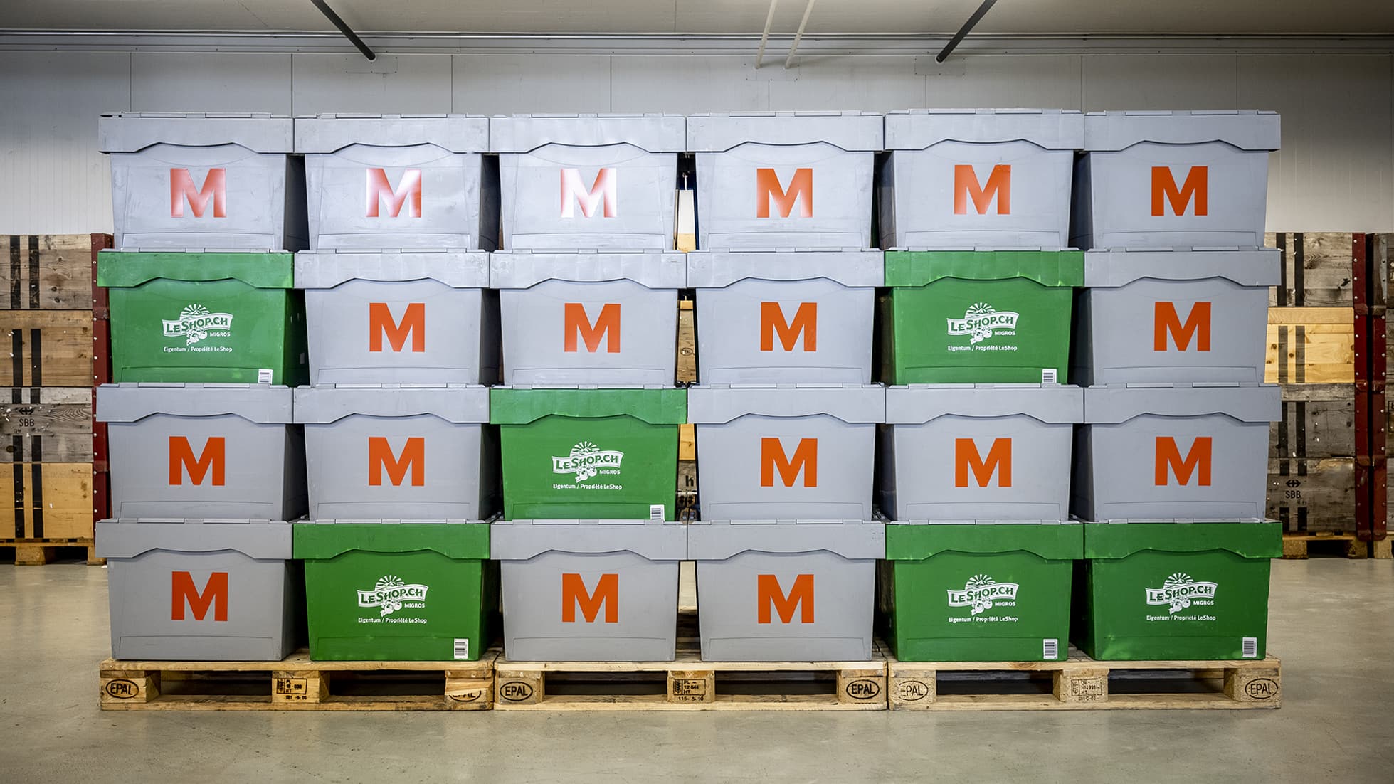 Verschiedene Boxen mit dem Migros Logo