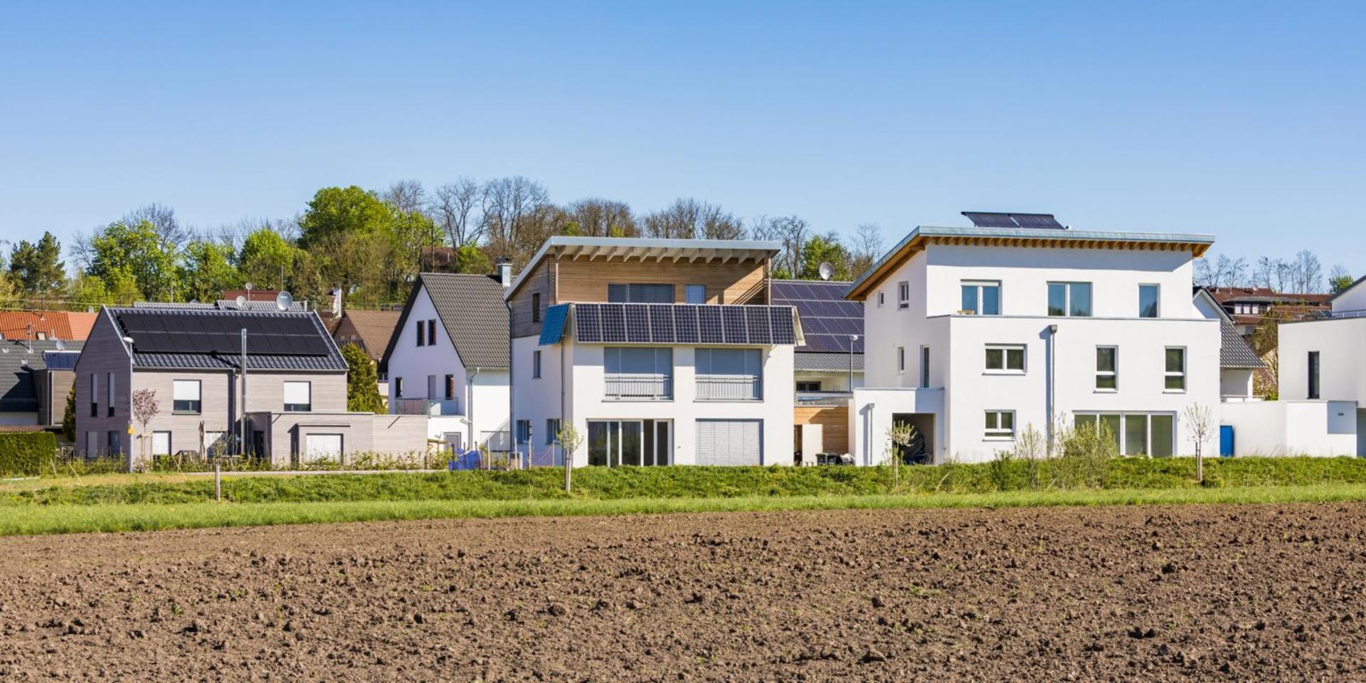 A residential estate with houses that have solar panels on the roof.