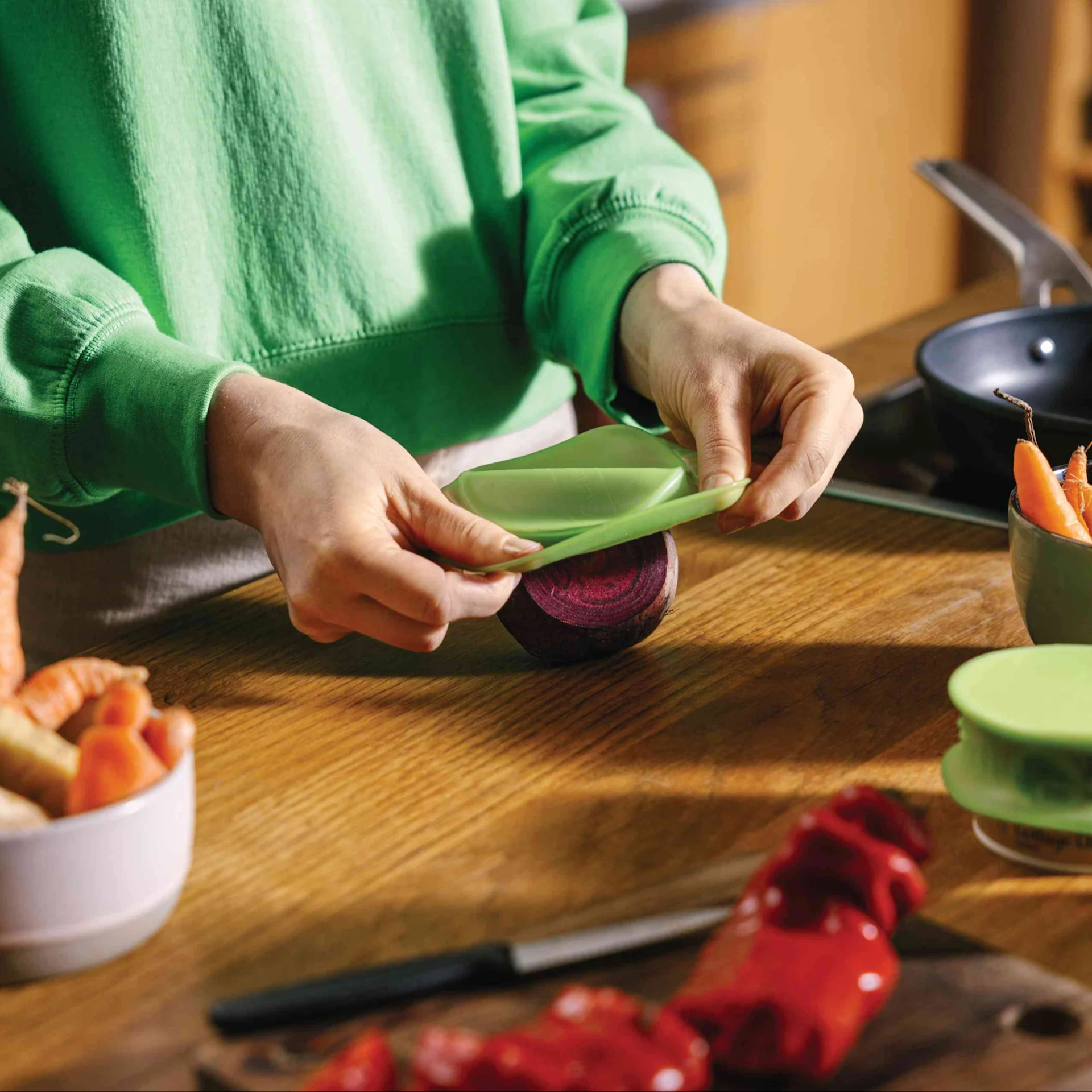 A person stores their food in reusable packaging.