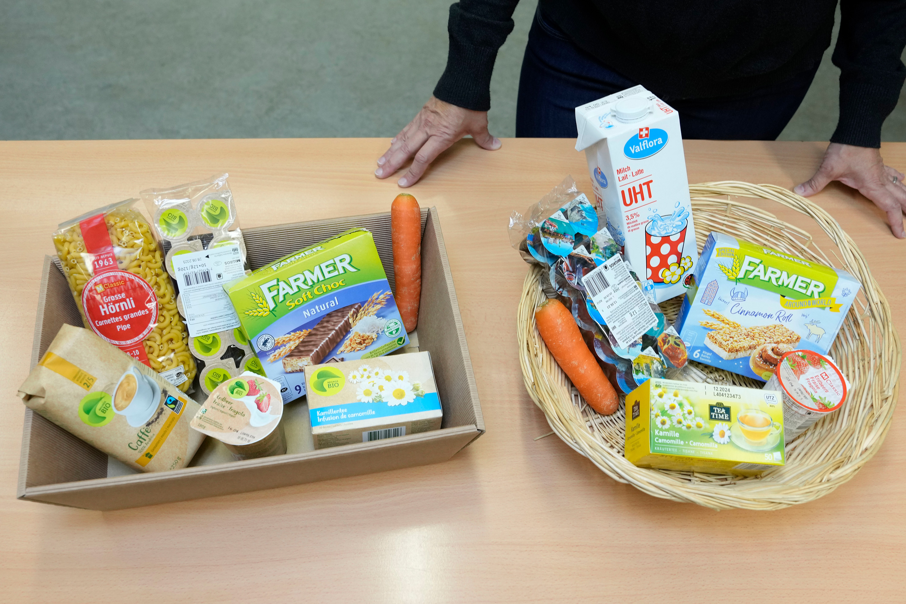 Two shopping baskets with Migros products