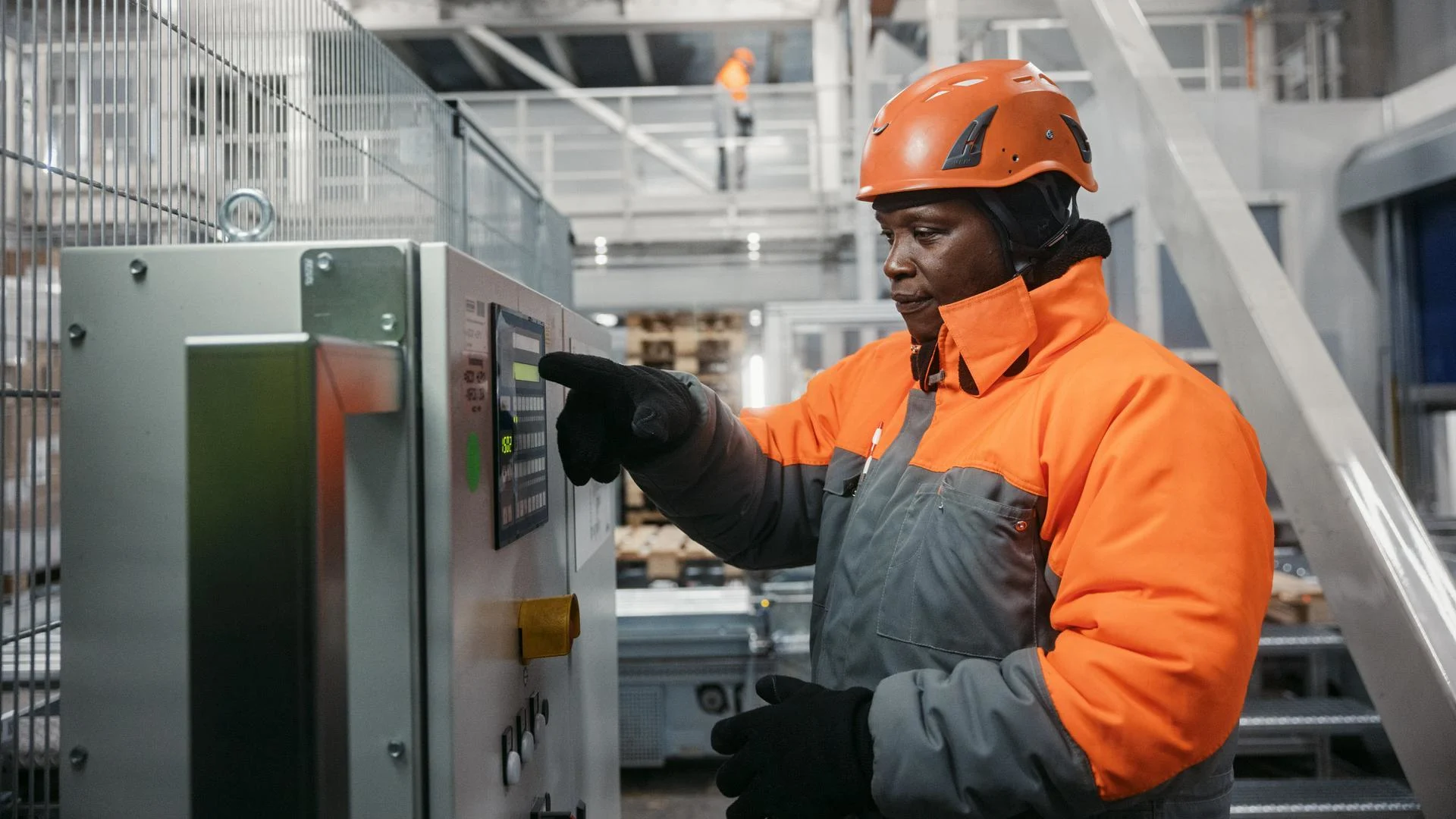 Employee in protective clothing operates a machine