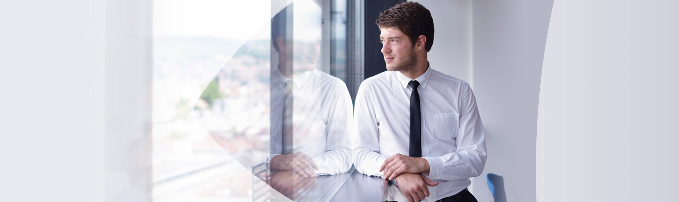 Man in office staring out window