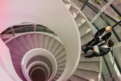 Business people talking on circular staircase