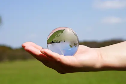Glass globe being held in a person's hand