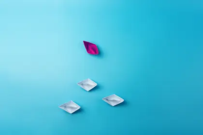 Several paper boats on a blue background