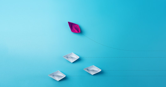 Several paper boats on a blue background
