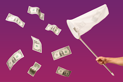 Dollar bills floating with net trying to catch them