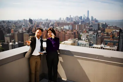 Business people discussing while standing on building terrace