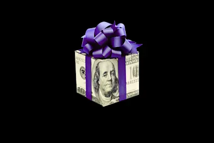 square gift box wrapped with paper of a U.S. one hundred dollar bill, tied with purple ribbon. 