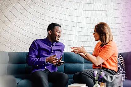Man and woman sitting on couch talking