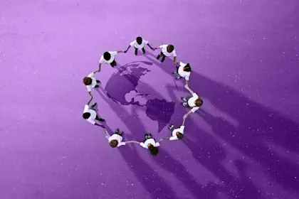 Children holding hands in circle around a picture of the earth