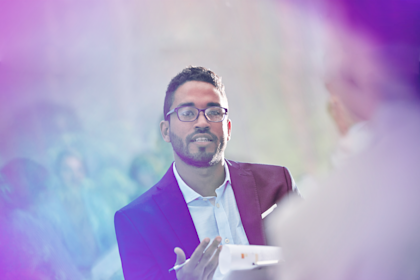 Man holding clipboard during a meeting