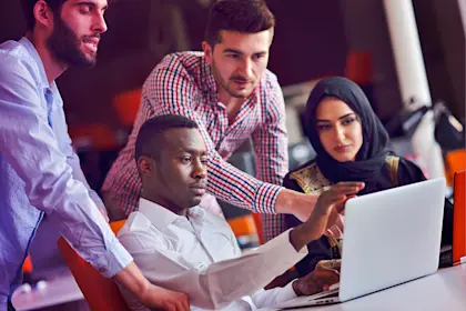 Group of business people looking at computer screen during meeting