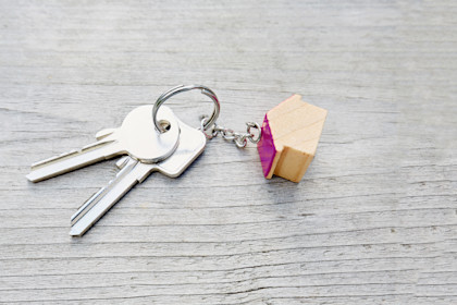 keys with a wooden house keychain
