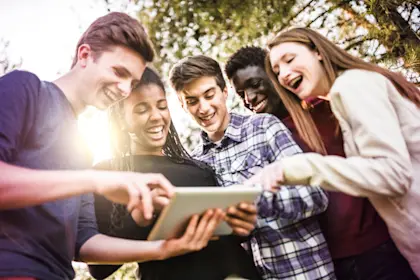 People around tablet smiling