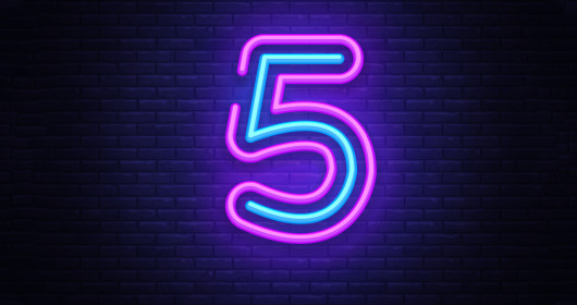 Number 5 neon glow sign on brick wall