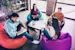 colleagues lounging together on colorful bean bag chairs